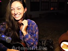 Camgirl tries to hold back her moans while playing the guitar