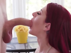 Redhaired woman  is giving a blowjob to  her lover