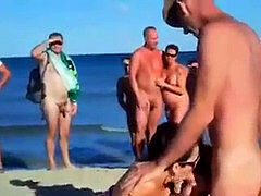 four mates have fuckfest on bare beach in front of crowd