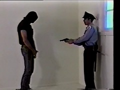A guy with a mask fucks a policeman in the ass and cums on his chest