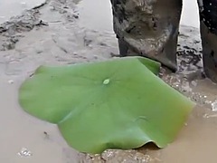 Two Thai men in high boots swim in the mud!