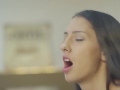 A brunette with a sexy smile is licking a cock in the office