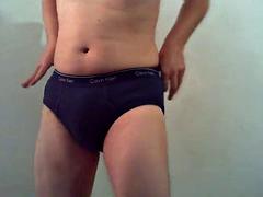 Pelling off four layers of blue Calvin Klein briefs