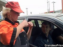 Blonde old woman pleases two strangers in the fields