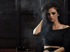 Curly-haired smoker talks on the phone